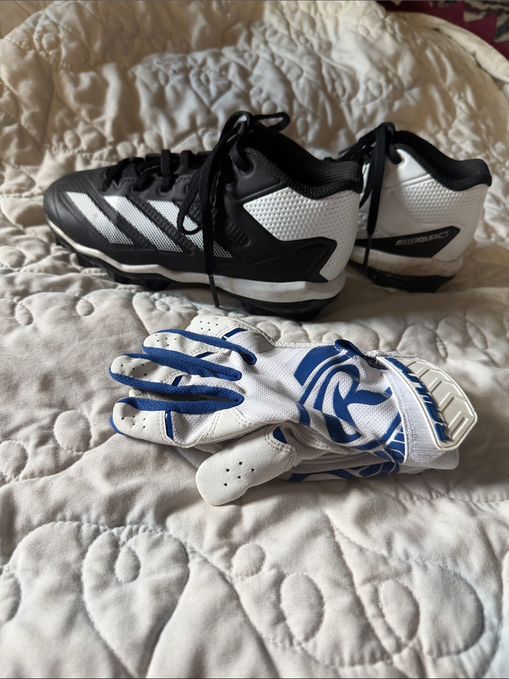 Youth baseball cleats and batting gloves